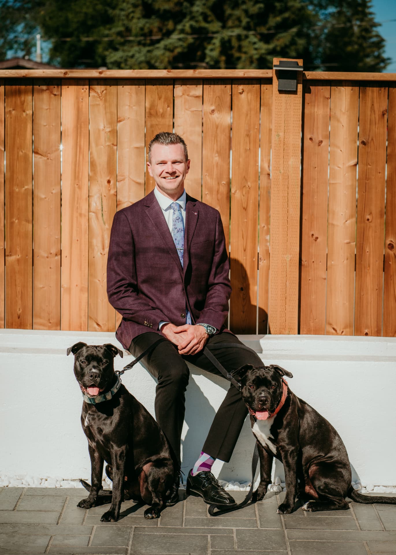 Jordan Bird outside a Lloydminster home with his two dogs